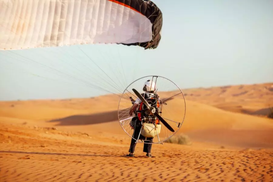 a-paraglider-prepares-to-fly-over-the-desert-in-du-2022-04-14-17-03-12-utc-900×600.jpg